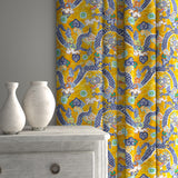 Velvet curtains upholstered in a printed velvet fabric with a intricate mirror dragon design in yellow colours.