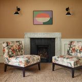 Chairs in a printed linen fabric with bouquets of roses on a tea-stained background.