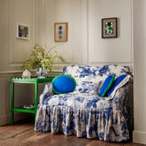 Sofa in a printed linen fabric with bouquets of roses in blue and white colours.