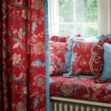 Curtains and cushions in a printed linen fabric with tree of life design in red and blue colours.