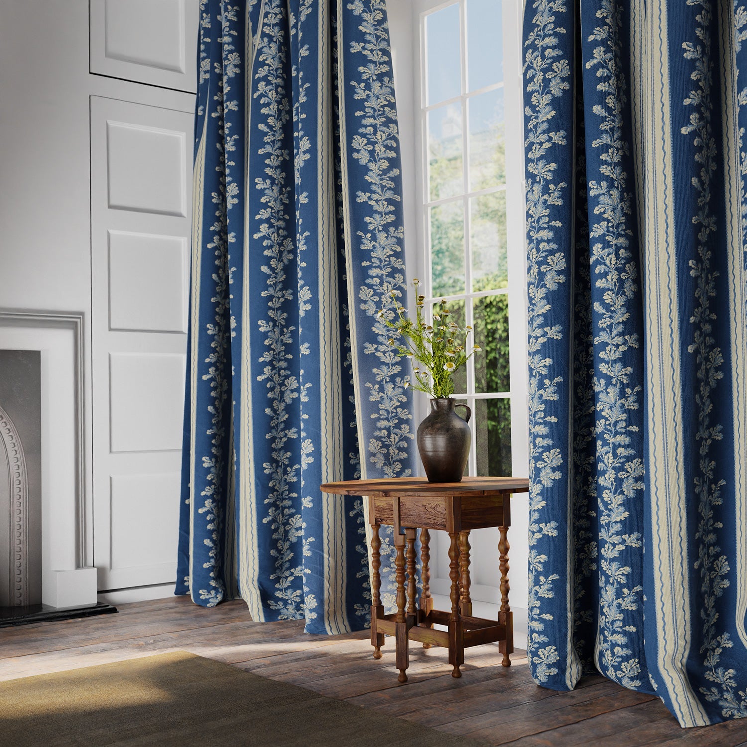 Curtains in a printed linen fabric with blue and white stripes and an oak-leaf motif.
