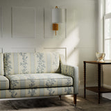Sofa in a printed linen fabric with grey and white stripes and an oak-leaf motif.