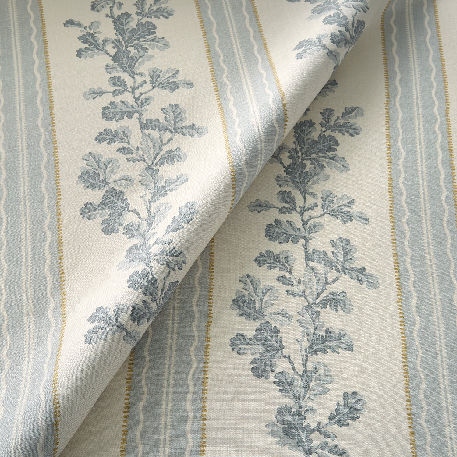 Printed linen fabric with grey and white stripes and an oak-leaf motif.