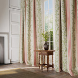 Curtains in a  printed linen fabric with pink and green stripes and an oak-leaf motif.