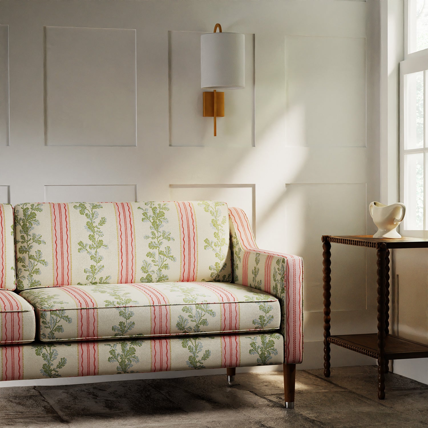 Sofa in a printed linen fabric with pink and green stripes and an oak-leaf motif.