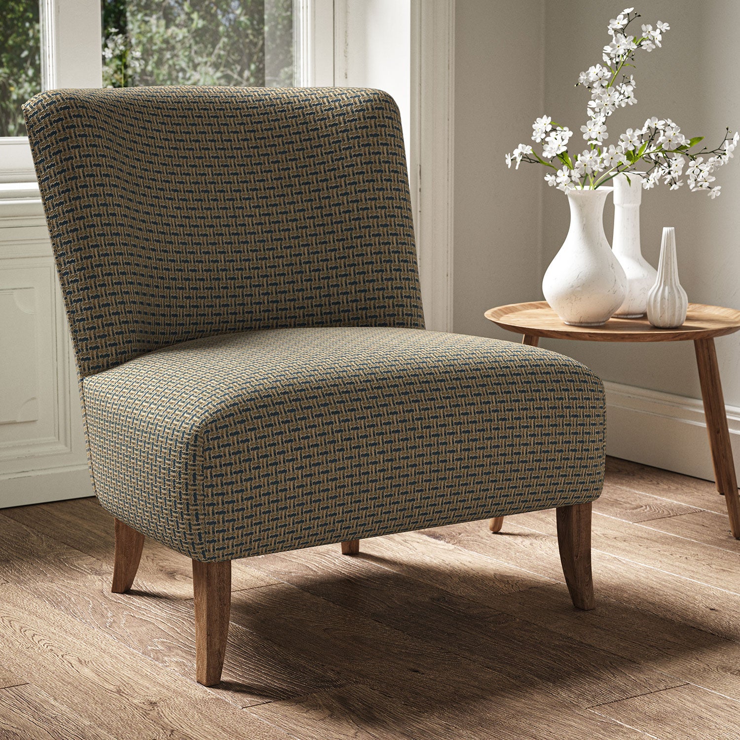 Armchair in a printed linen fabric with textural weave pattern in brown and blue colours.