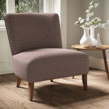 Armchair in a printed linen fabric with textural weave pattern in pink and black colours.