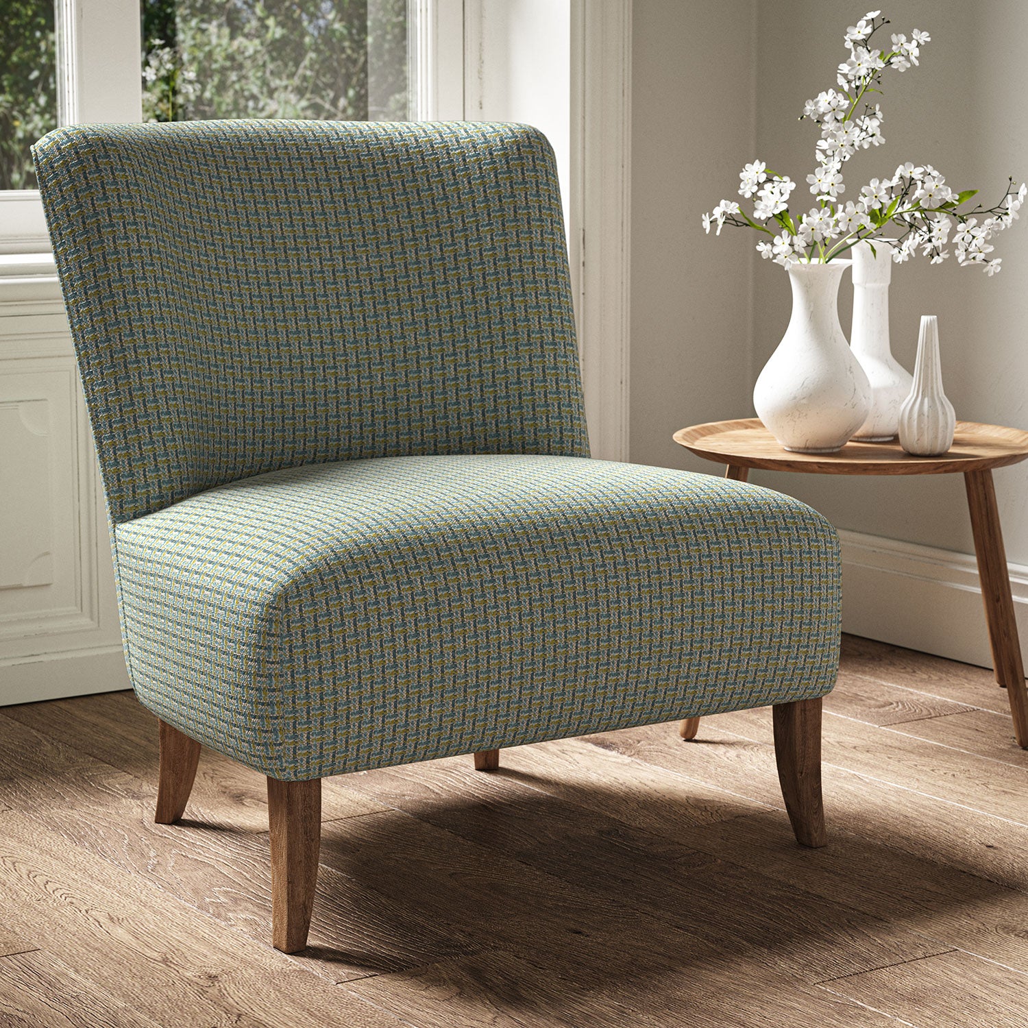 Armchair in a printed linen fabric with textural weave pattern in blue and yellow colours.