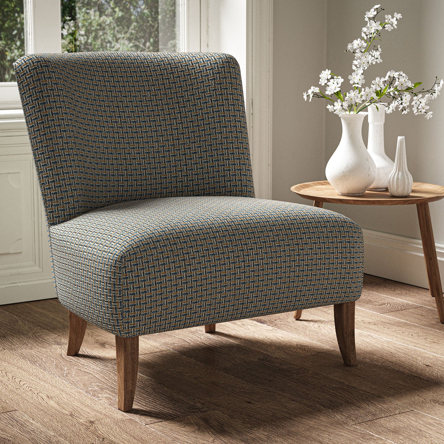 Armchair in a printed linen fabric with textural weave pattern in beige colours.