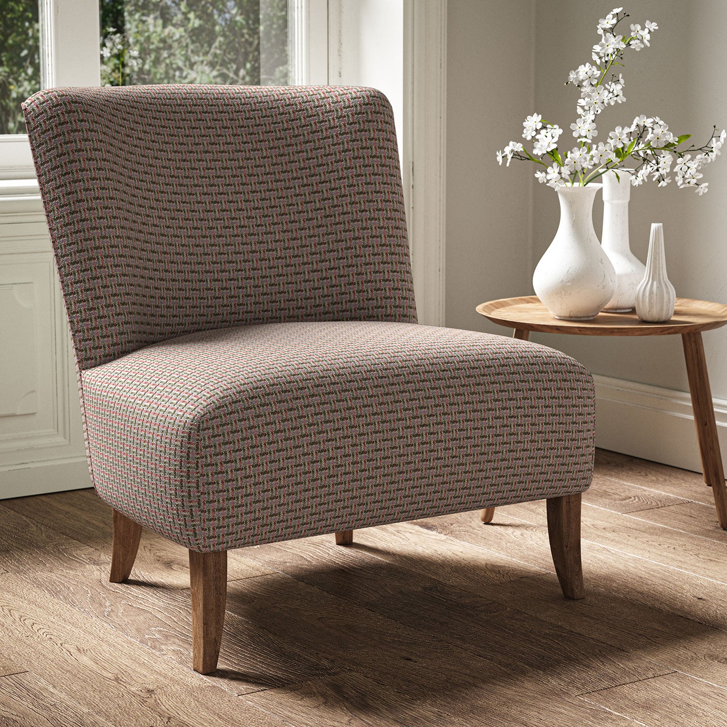 Armchair in a printed linen fabric with textural weave pattern in pink and green colours.