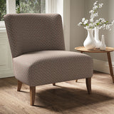 Armchair in a printed linen fabric with textural weave pattern in pink and green colours.