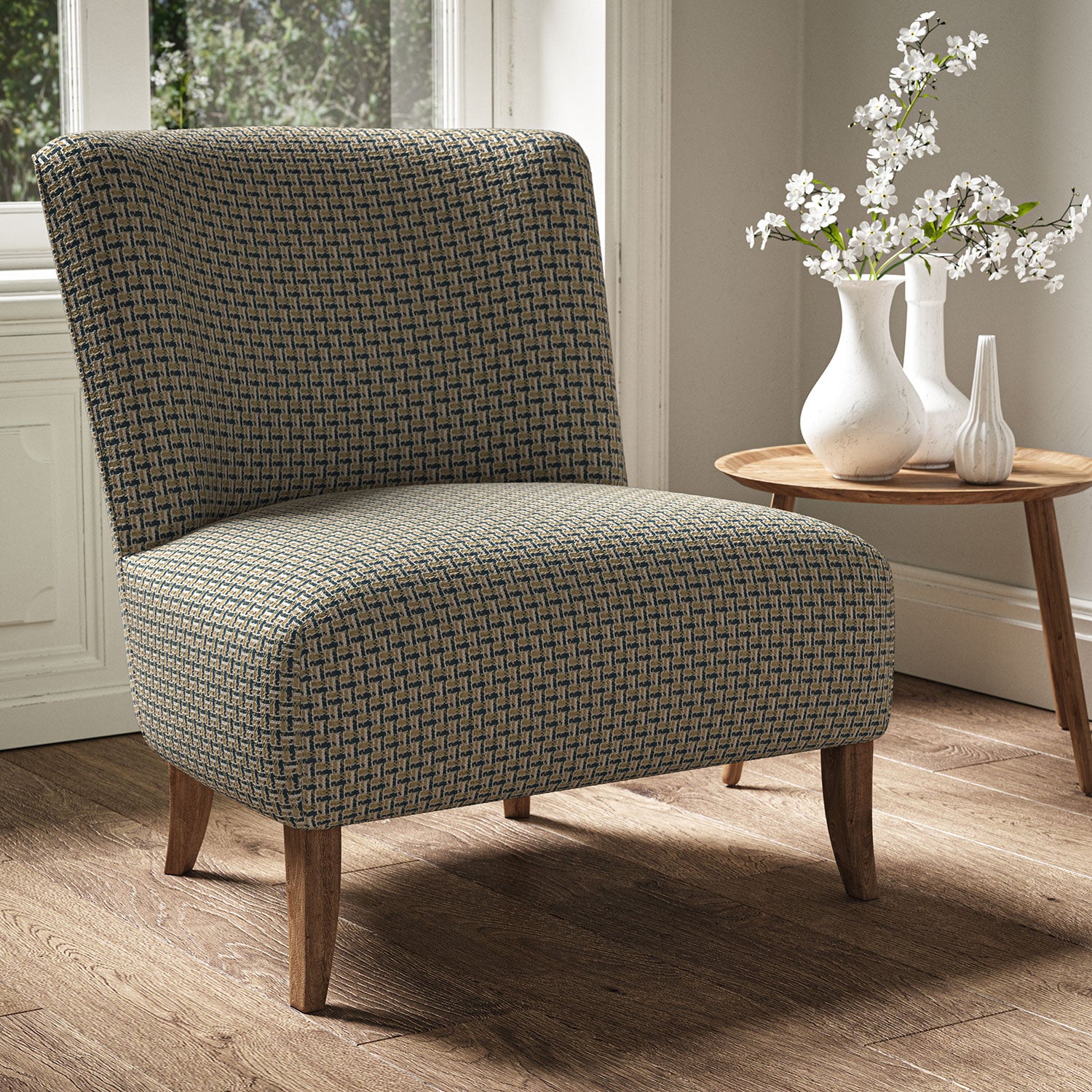 Armchair in a printed linen fabric with textural weave pattern in brown and blue colours.