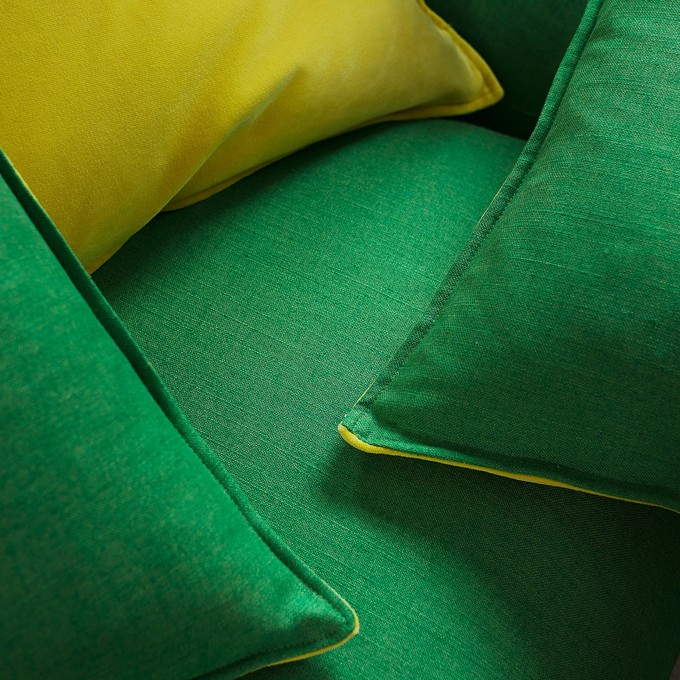 Yellow and green cushions in Juno – a plain fabric
