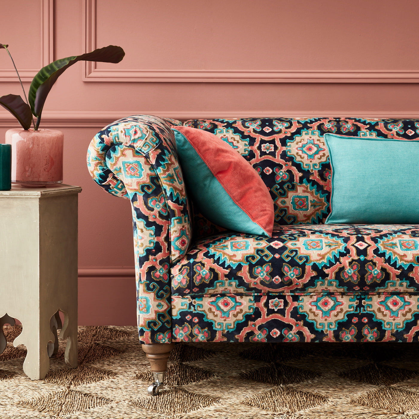 Velvet sofa upholstered in a printed velvet fabric with an oriental geometric design in multicolours
