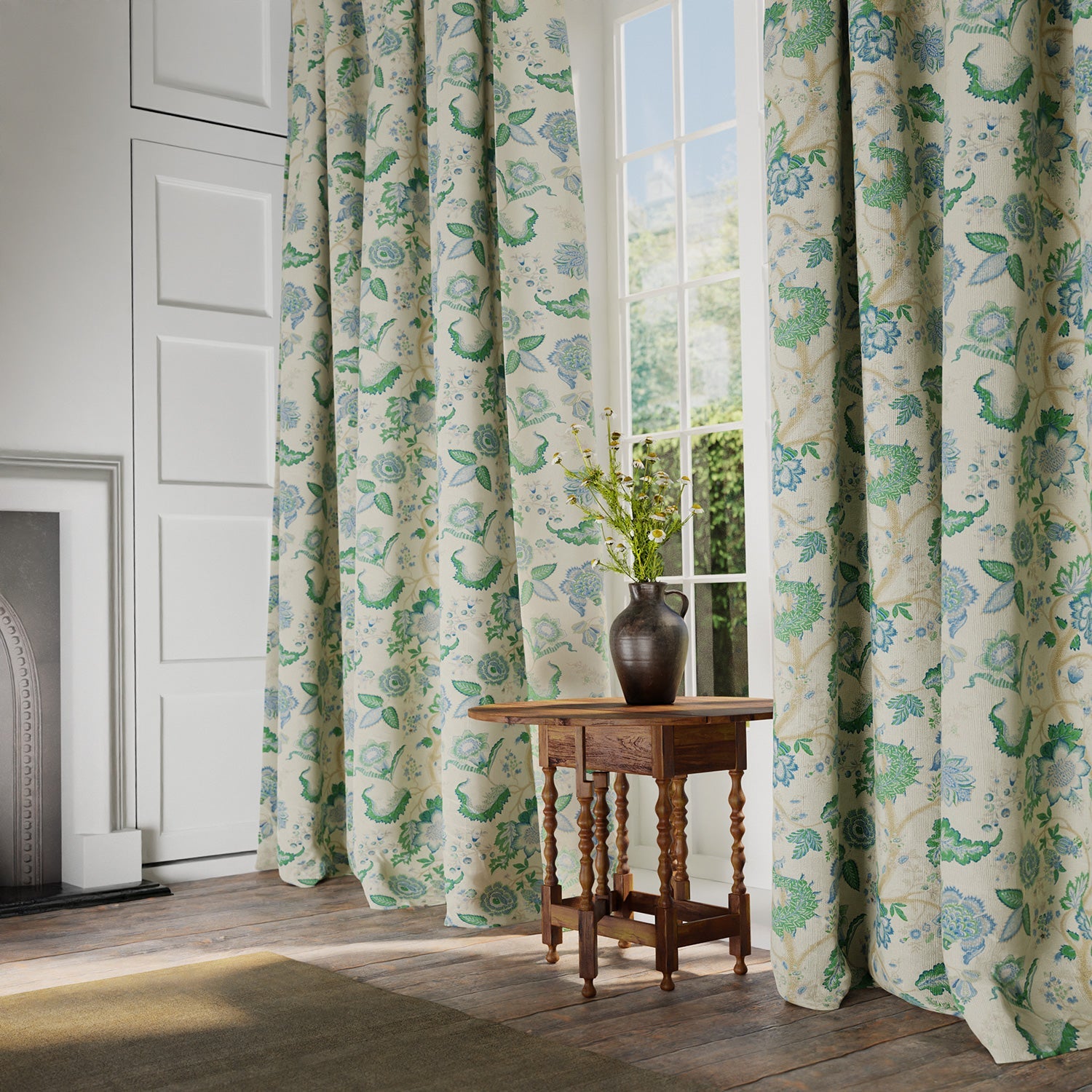 Curtains in a printed linen fabric with tree of life design in blue and green colours.