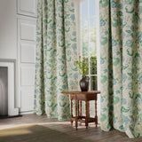 Curtains in a printed linen fabric with tree of life design in blue and green colours.