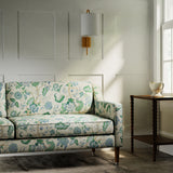 Sofa in a printed linen fabric with tree of life design in blue and green colours.
