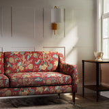Sofa in a printed linen fabric with tree of life design in red and blue.