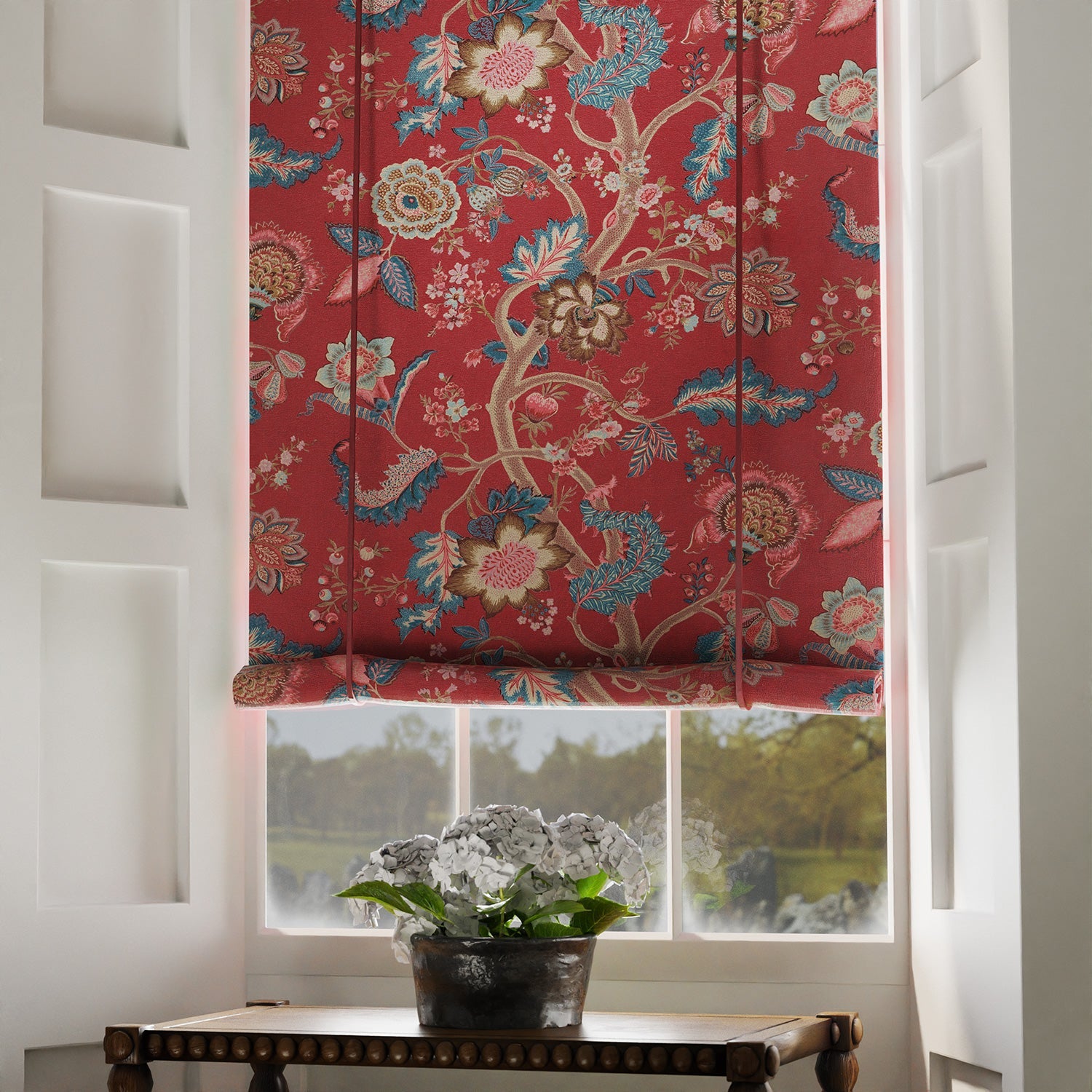 Blinds in a printed linen fabric with tree of life design in red and blue colours.