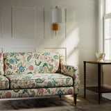 Sofa in a printed linen fabric with tree of life design in multicolours.