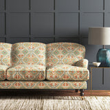 Velvet sofa upholstered in a printed velvet fabric with an oriental geometric design in multicolours
