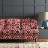 Velvet sofa upholstered in a printed velvet fabric with an oriental geometric design in pink and purple colours