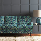 Velvet sofa upholstered in a printed velvet fabric with an oriental geometric design in blue and green colours