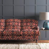 Velvet sofa upholstered in a printed velvet fabric with an oriental geometric design in red colours