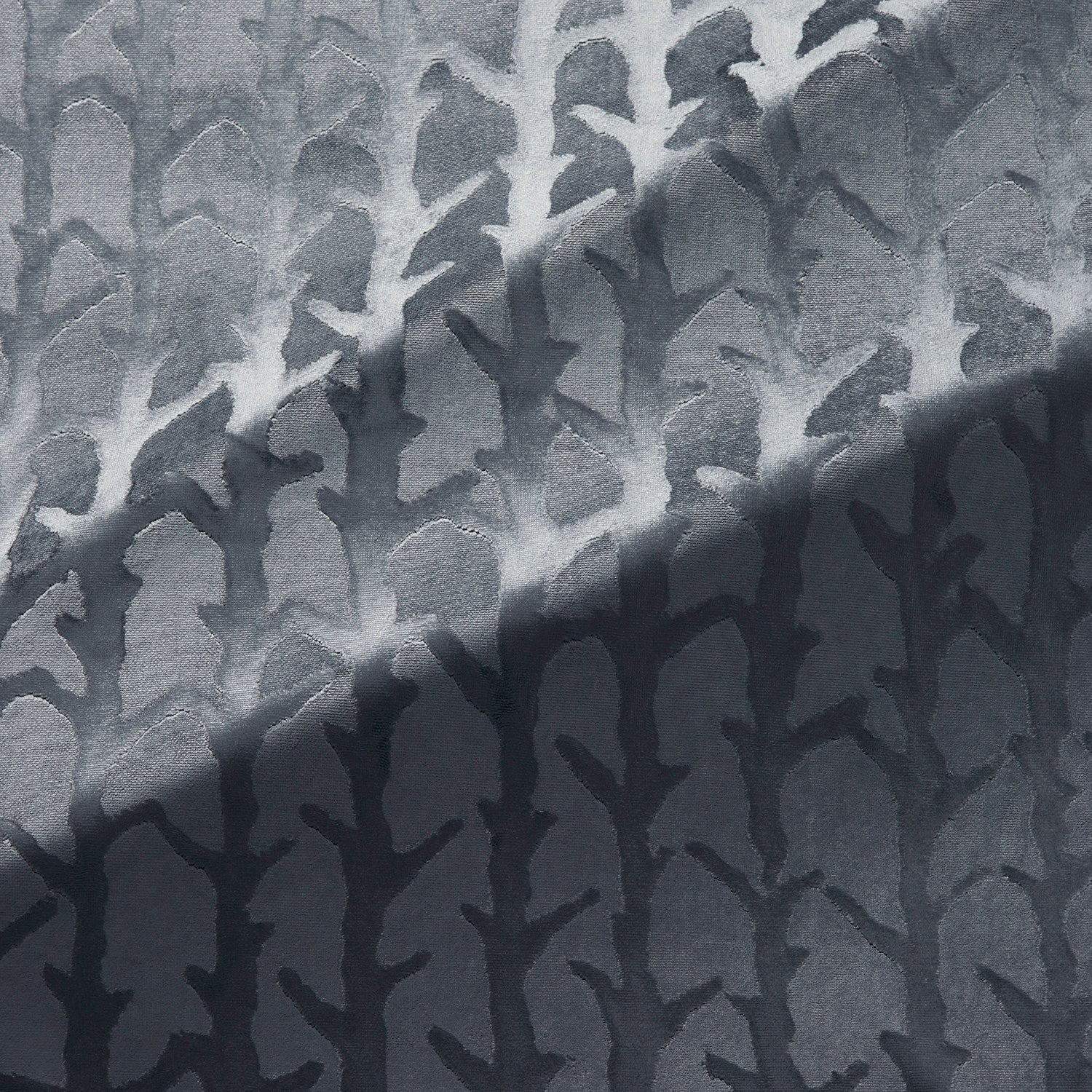 Fabric swatch of a blue velvet fabric with abstract branch design, suitable for curtains and upholstery 