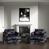 Velvet armchairs upholstered in a printed velvet fabric with enchanting landscape of abstract clouds design in multicolours.