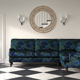 Velvet sofa upholstered in a printed velvet fabric with enchanting landscape of abstract clouds design in blue and green colours.