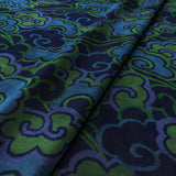 Printed velvet fabric with enchanting landscape of abstract clouds design in blue and green colours, for upholstery and curtain use.