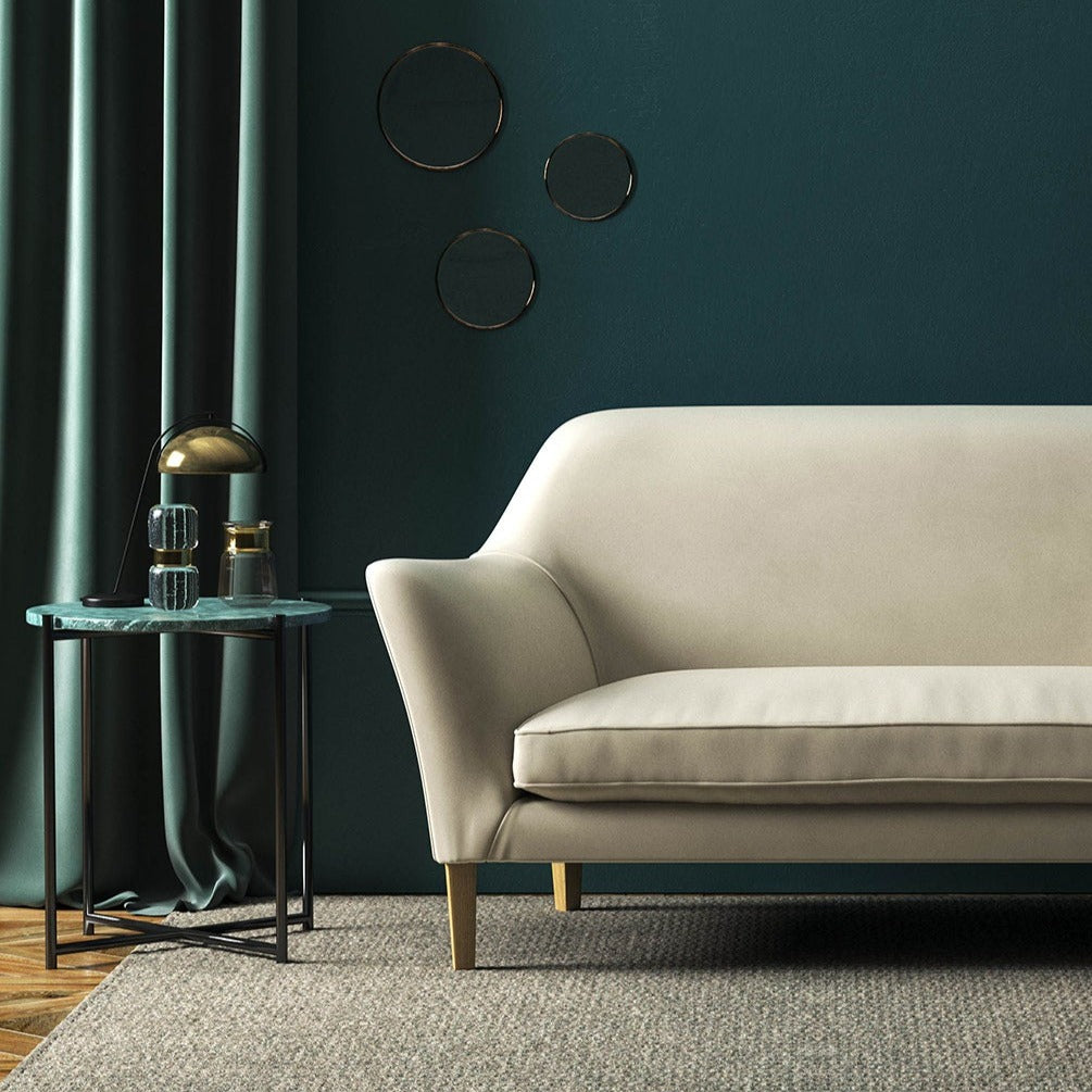 Sofa covered in a cream velvet upholstery fabric 