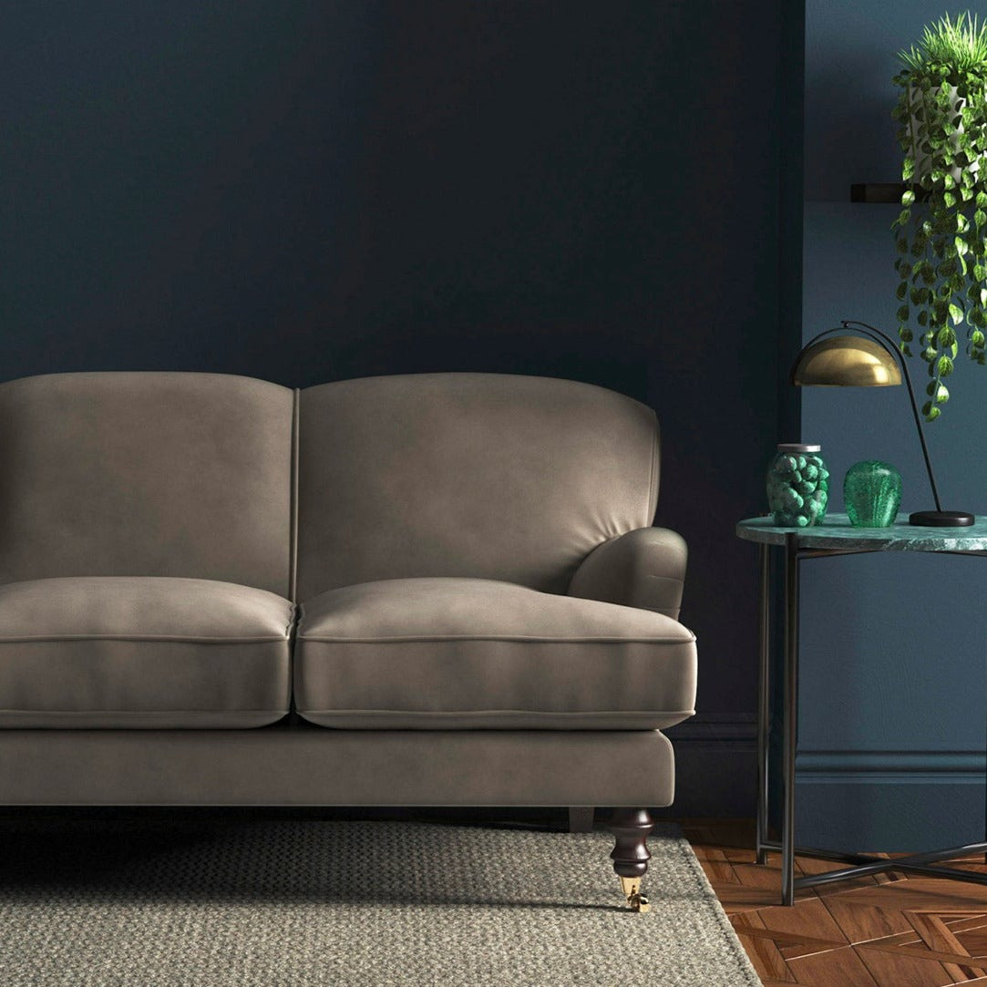 Sofa covered in a grey velvet upholstery fabric