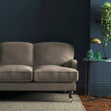 Sofa covered in a grey velvet upholstery fabric