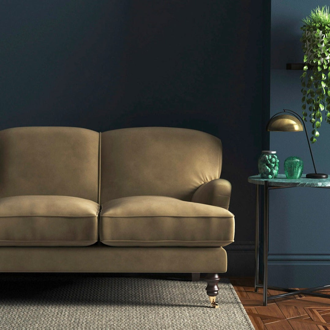 Sofa covered in a brown velvet upholstery fabric