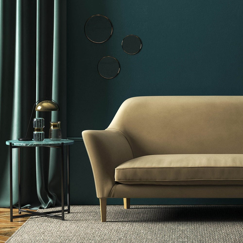 Sofa covered in a brown velvet upholstery fabric 
