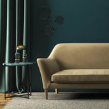 Sofa covered in a brown velvet upholstery fabric 