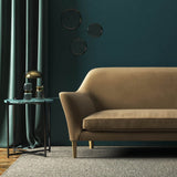 Sofa covered in a brown velvet upholstery fabric 