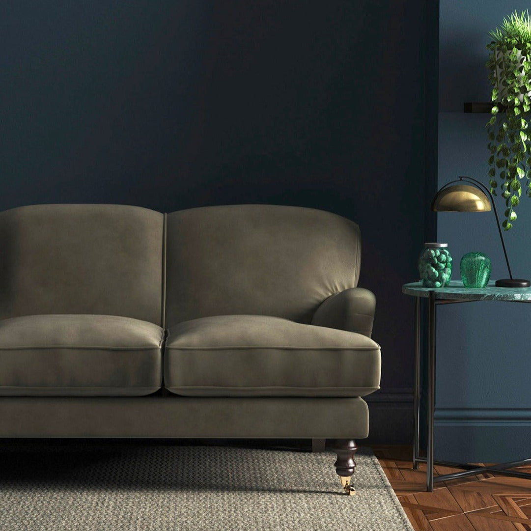 Sofa covered in a brown velvet upholstery fabric