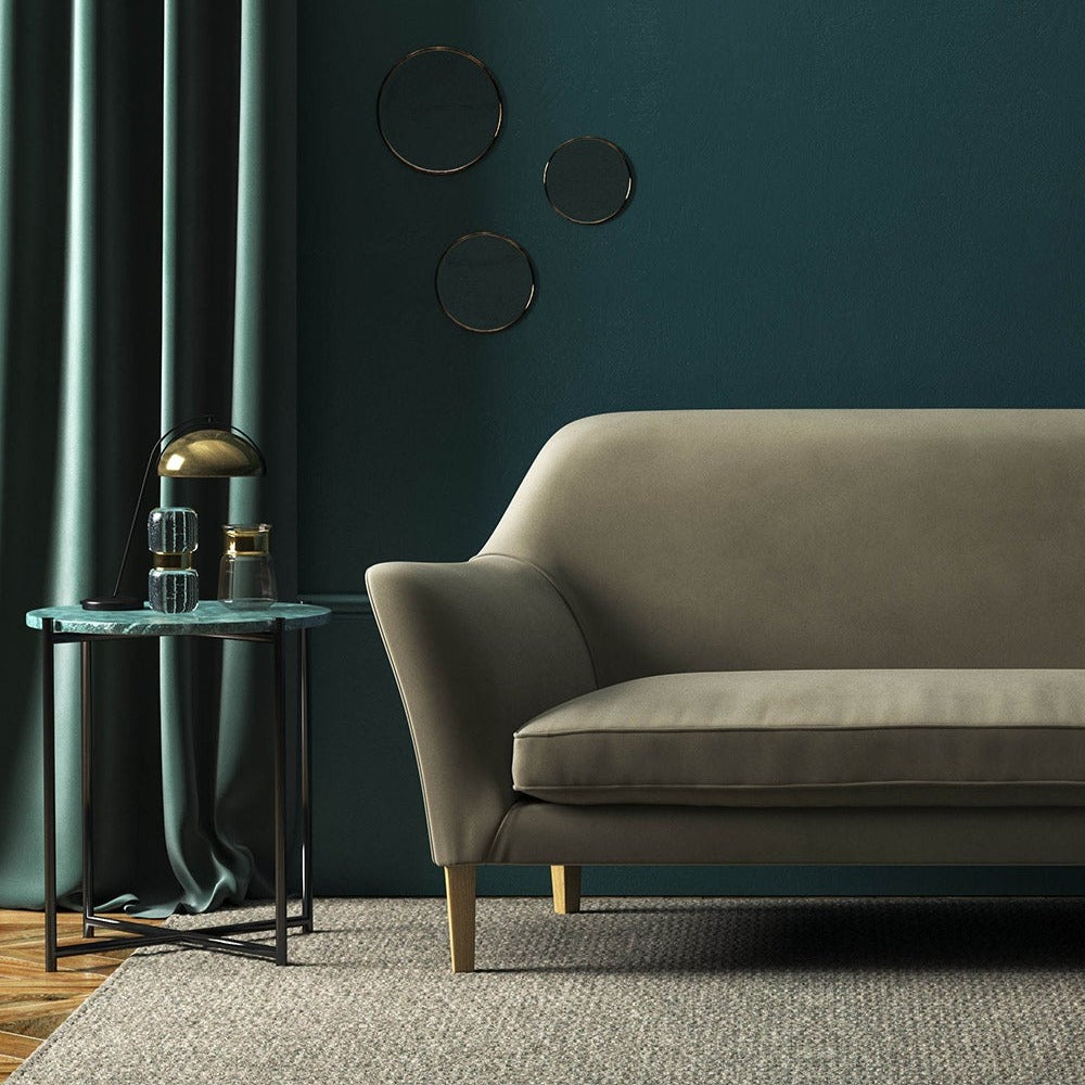 Sofa covered in a brown velvet upholstery fabric 