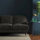 Sofa covered in a grey velvet upholstery fabric