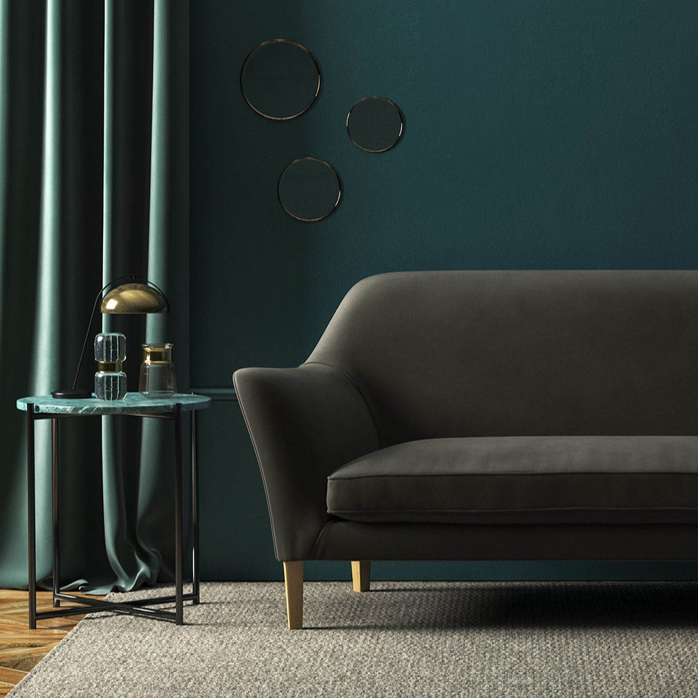 Sofa covered in a grey velvet upholstery fabric 