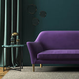 Sofa covered in a purple velvet upholstery fabric 