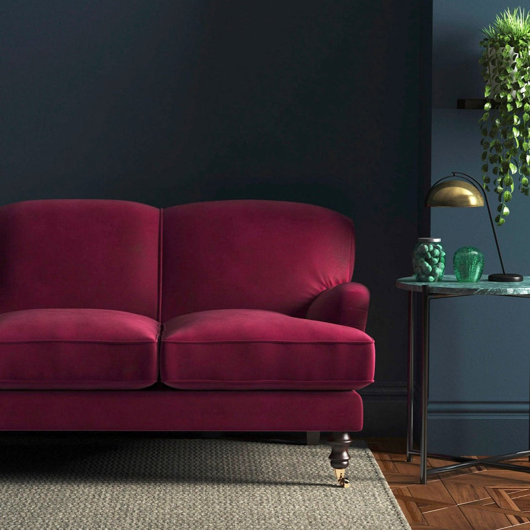 Sofa covered in a pink velvet upholstery fabric