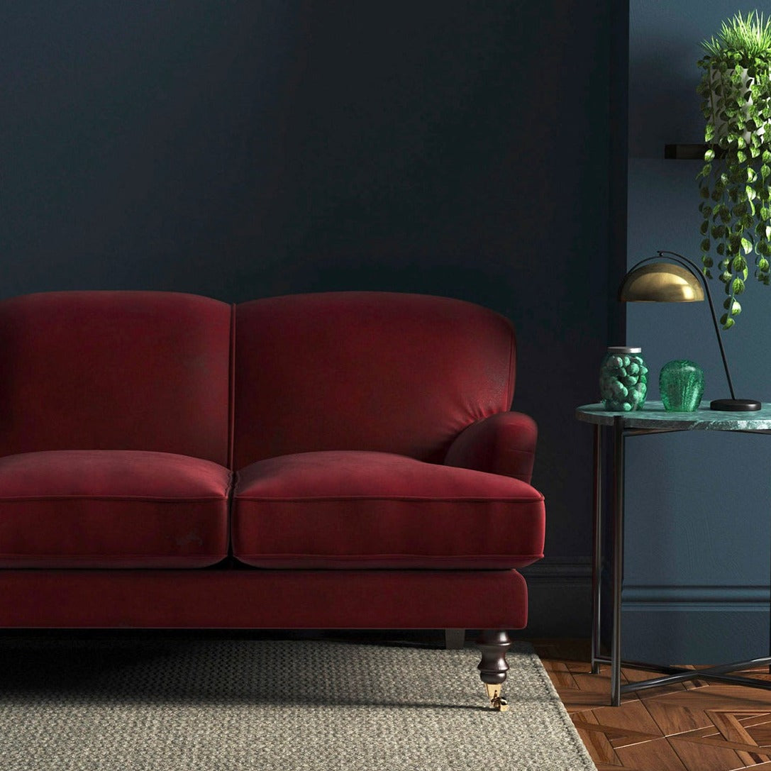 Sofa covered in a red velvet upholstery fabric