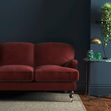 Sofa covered in a red velvet upholstery fabric