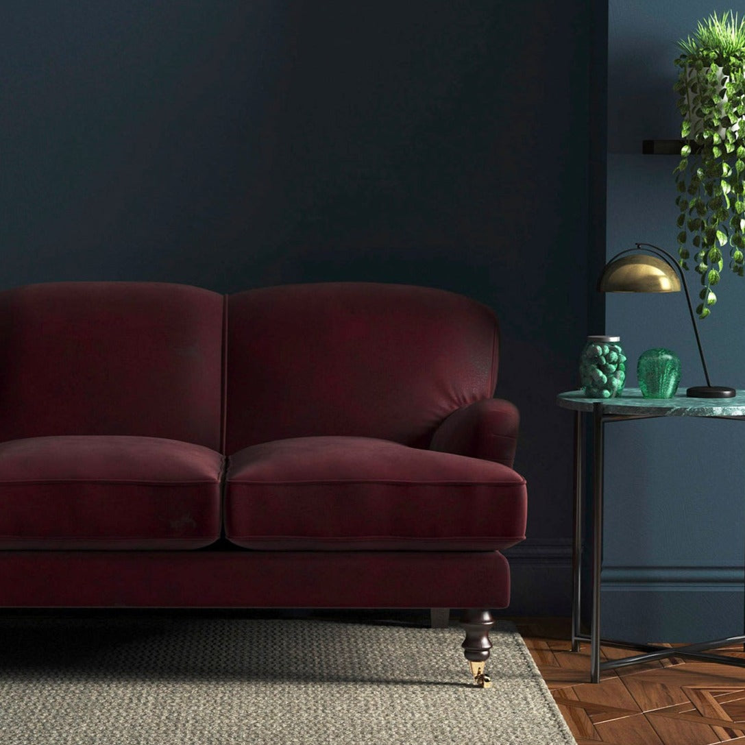 Sofa covered in a red velvet upholstery fabric