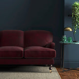 Sofa covered in a red velvet upholstery fabric