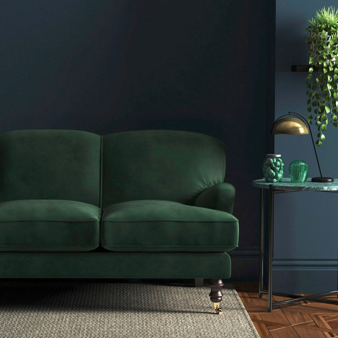 Sofa covered in a green velvet upholstery fabric